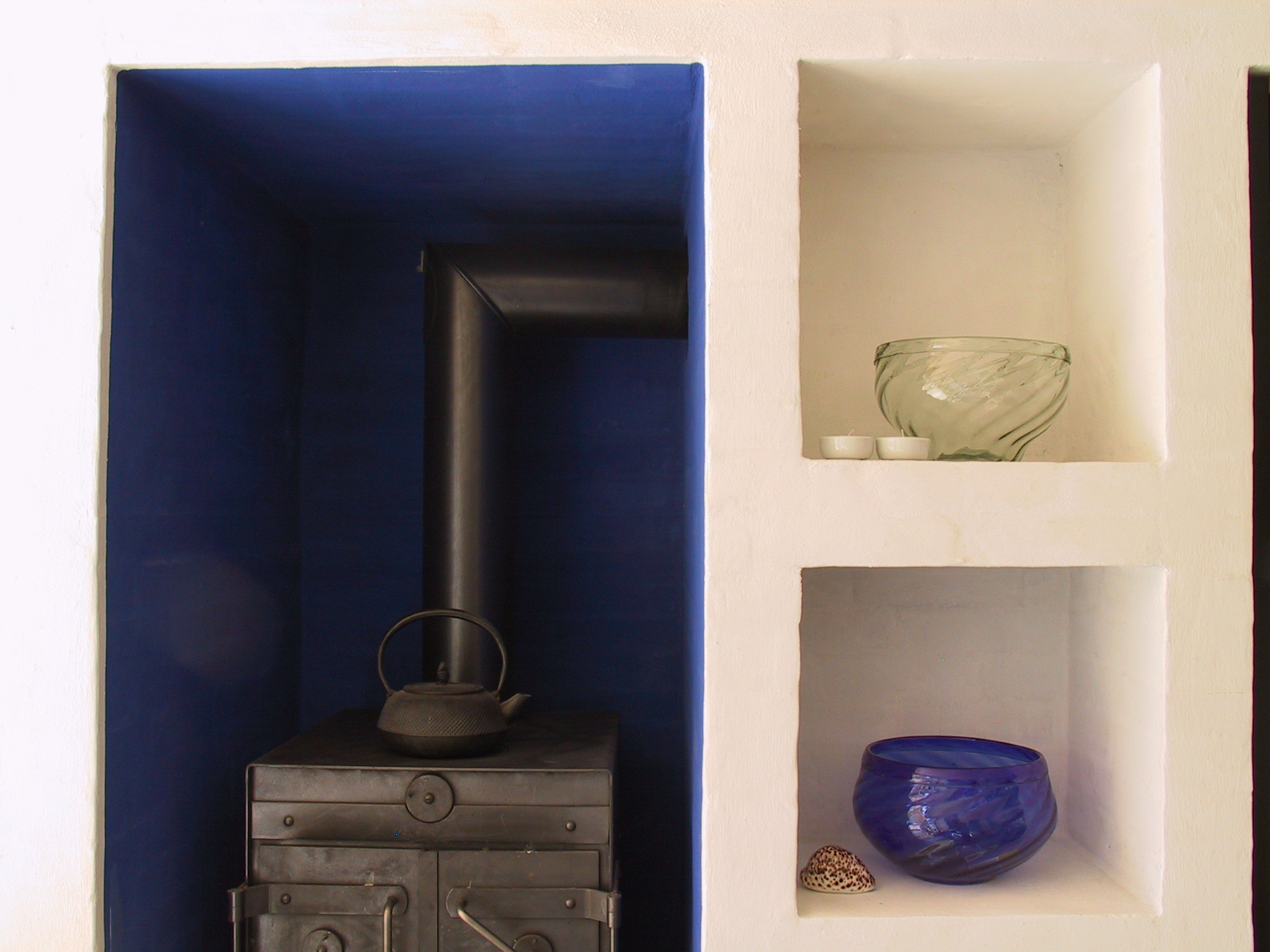 Wall niches with blue alcove and stove